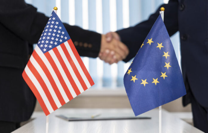 Political flags of European Union and United States of America on table. concept of negotiations, collaboration and cooperation of countries. agreement between governments.